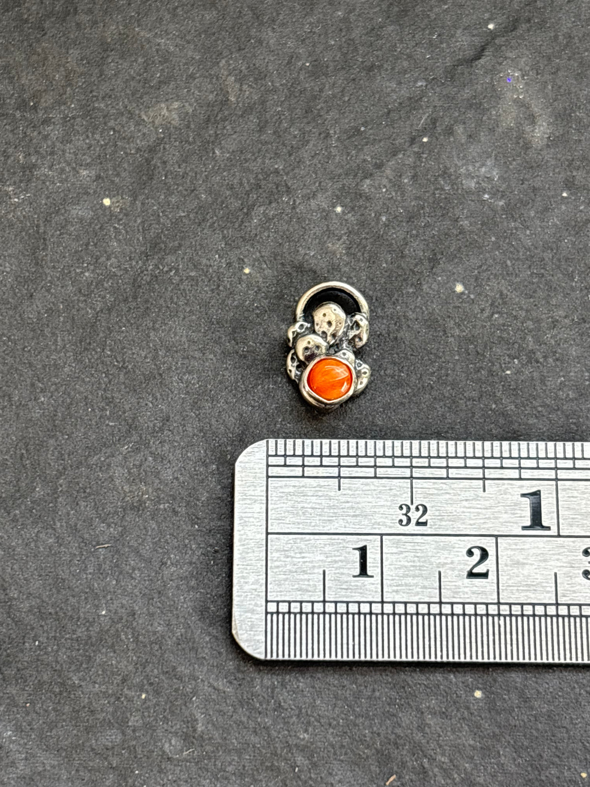 Sterling silver Baby Prickly Pear Cactus Charm with orange spiny oyster above a horizontal ruler for width reference.