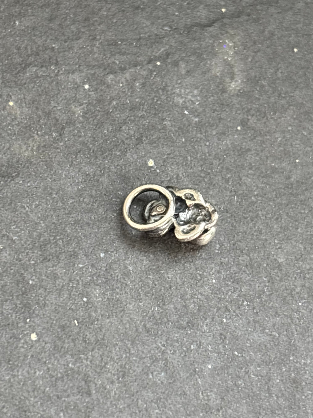 Back of the sterling silver Orange Spiny Oyster Baby Prickly Pear Cactus Charm, showing the attached bail.