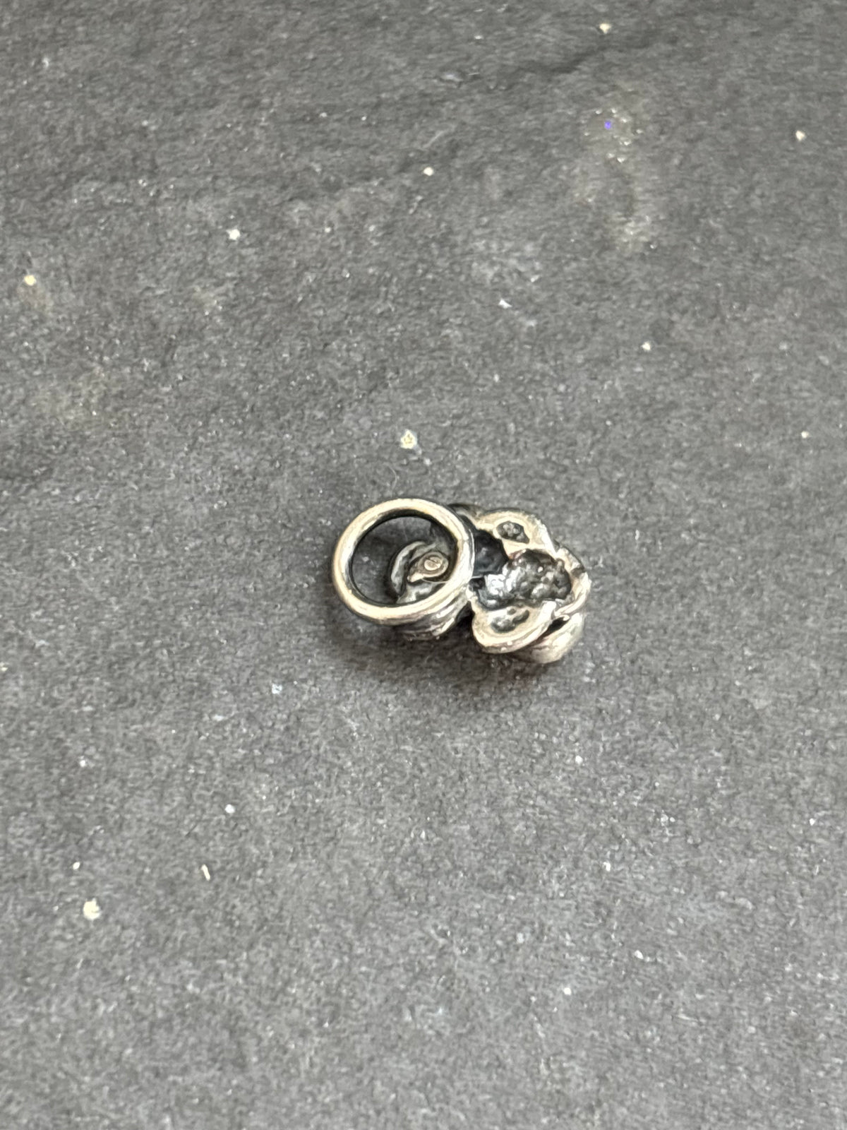 Back of the sterling silver Orange Spiny Oyster Baby Prickly Pear Cactus Charm, showing the attached bail.