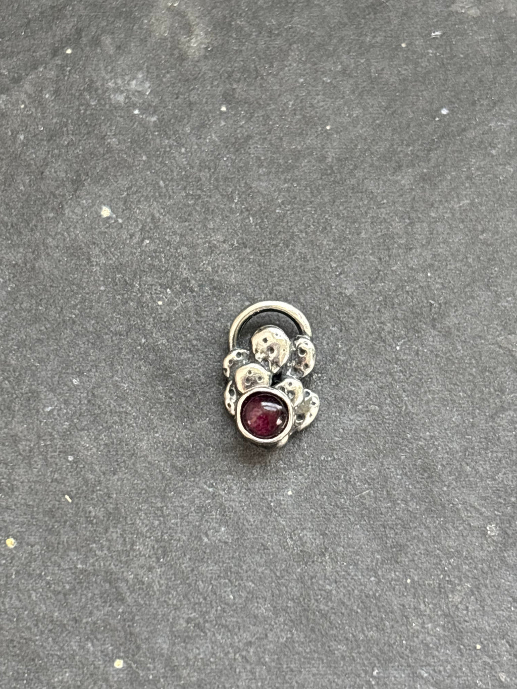 Front of a sterling silver Baby Prickly Pear Cactus Charm with purple spiny oyster.