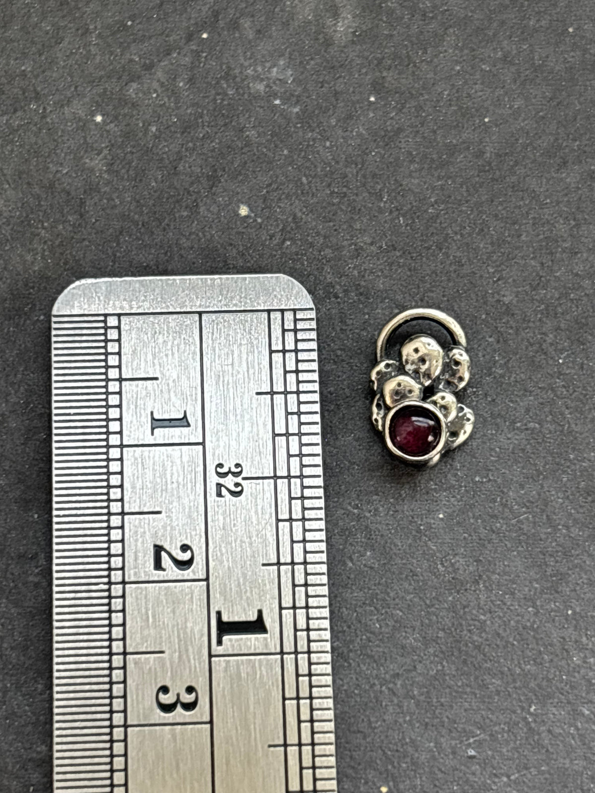 Sterling silver Baby Prickly Pear Cactus Charm with purple spiny oyster beside a vertical ruler for height reference.