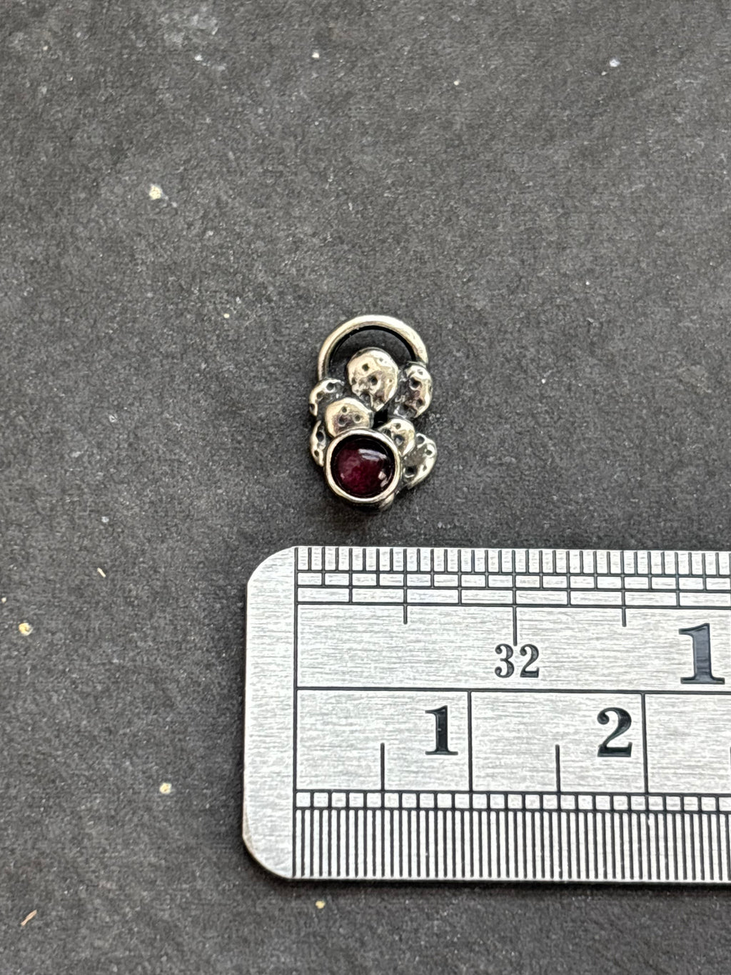 Sterling silver Baby Prickly Pear Cactus Charm with purple spiny oyster above a horizontal ruler for width reference.