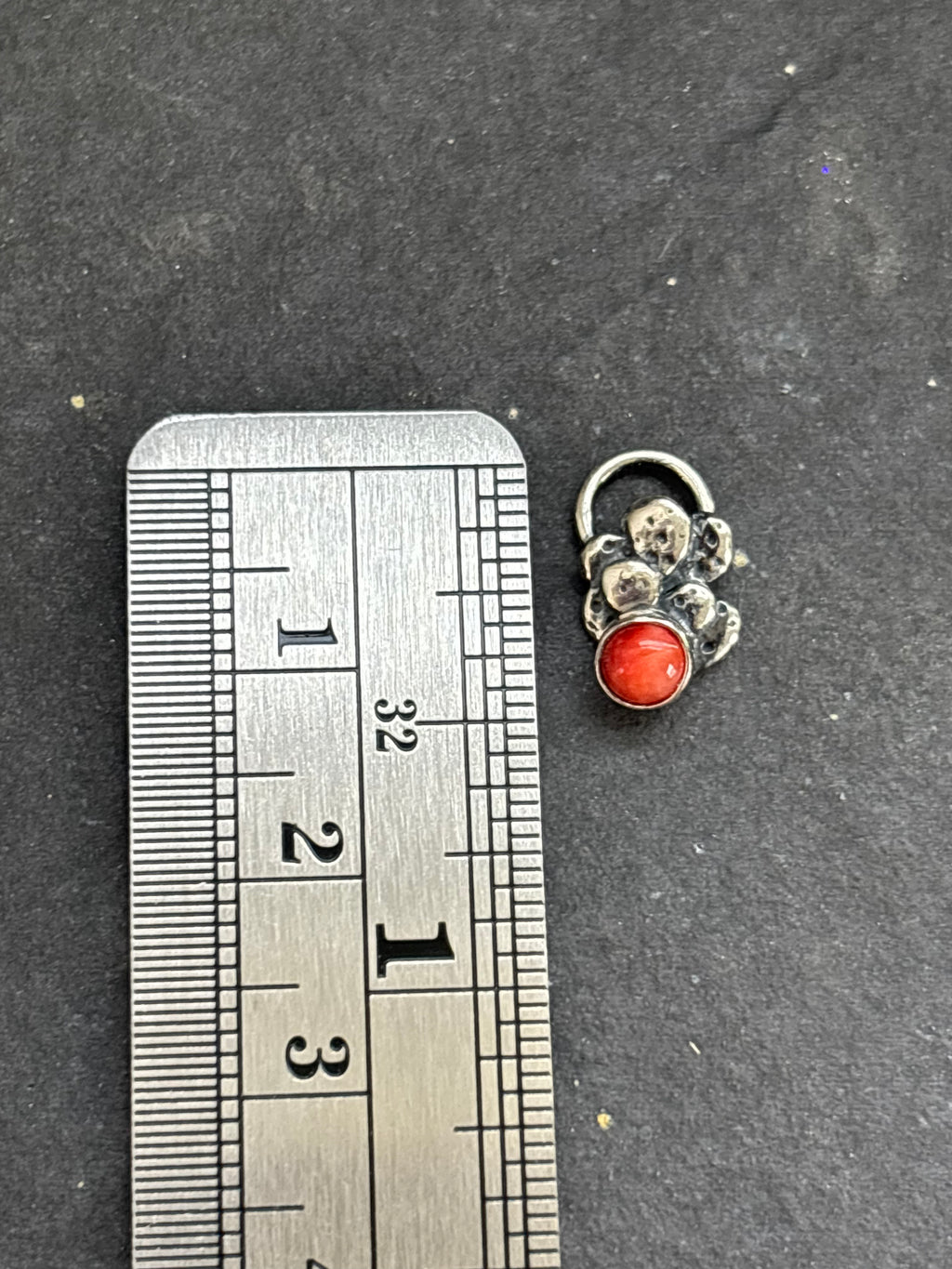 Sterling silver Baby Prickly Pear Cactus Charm with red spiny oyster beside a vertical ruler for height reference.