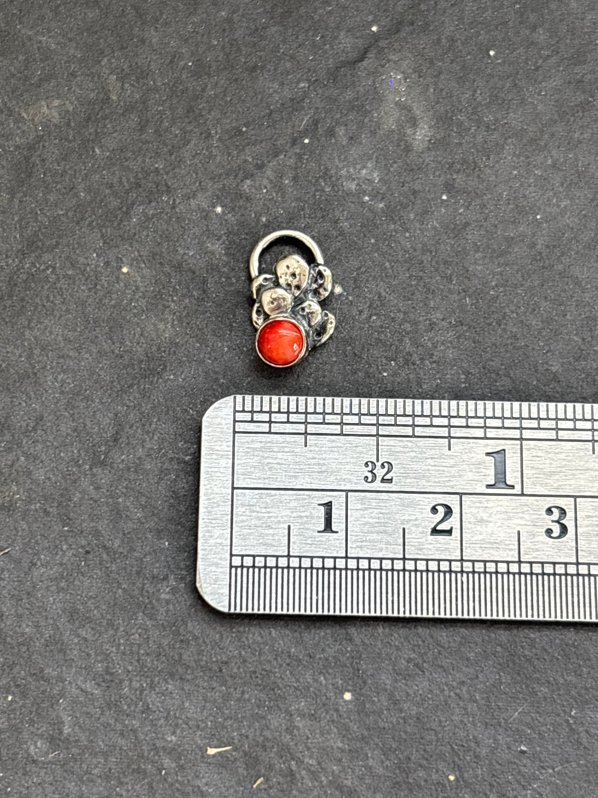 Sterling silver Baby Prickly Pear Cactus Charm with red spiny oyster above a horizontal ruler for width reference.
