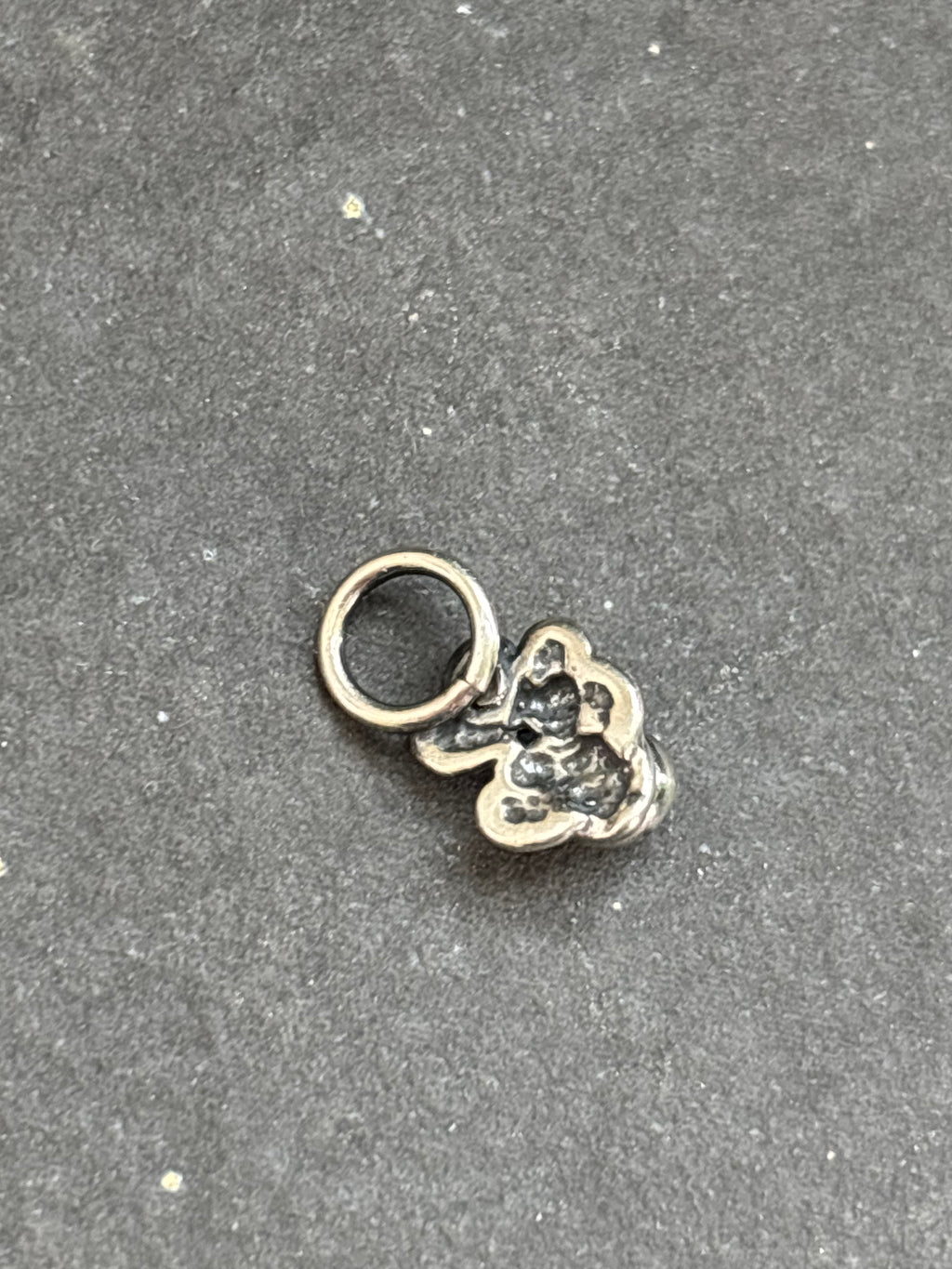 Back of the sterling silver White Buffalo Baby Prickly Pear Cactus Charm, showing the attached bail.